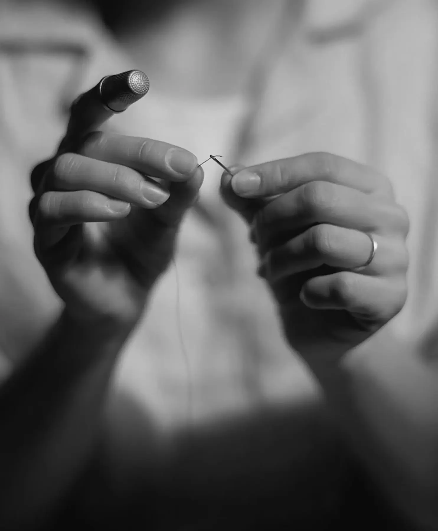 Hands sewing a Beltrami textile by needle