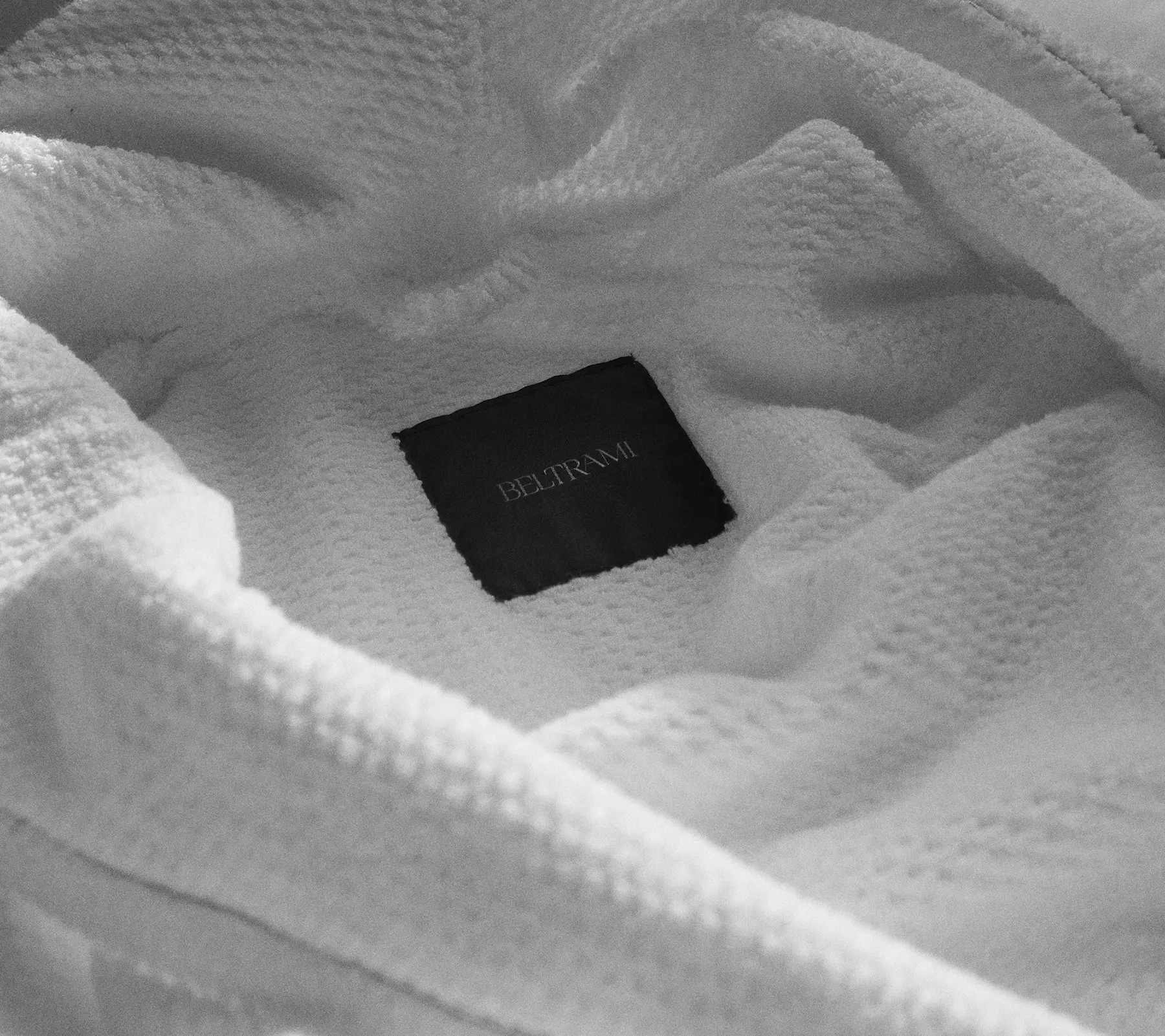 White fabric with black Beltrami logo