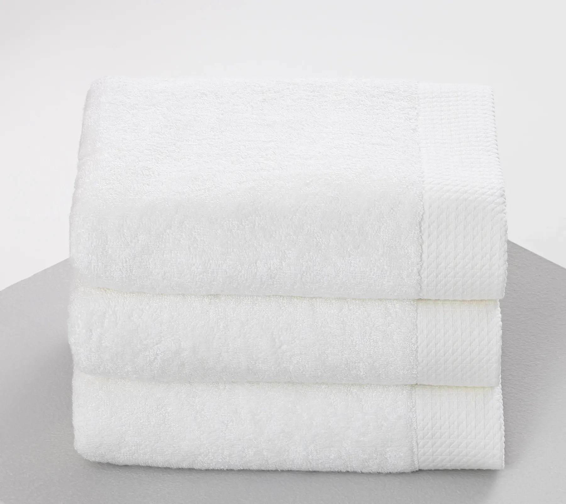 Folded white Beltrami towels, stacked