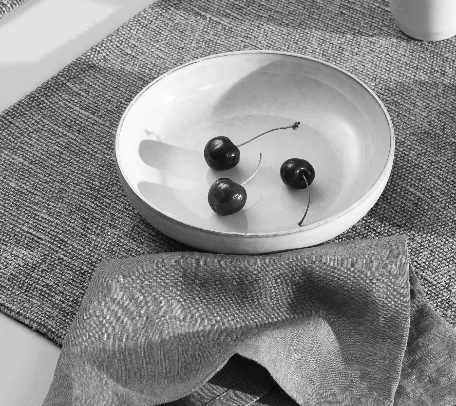 Bowl of cherries on table linen