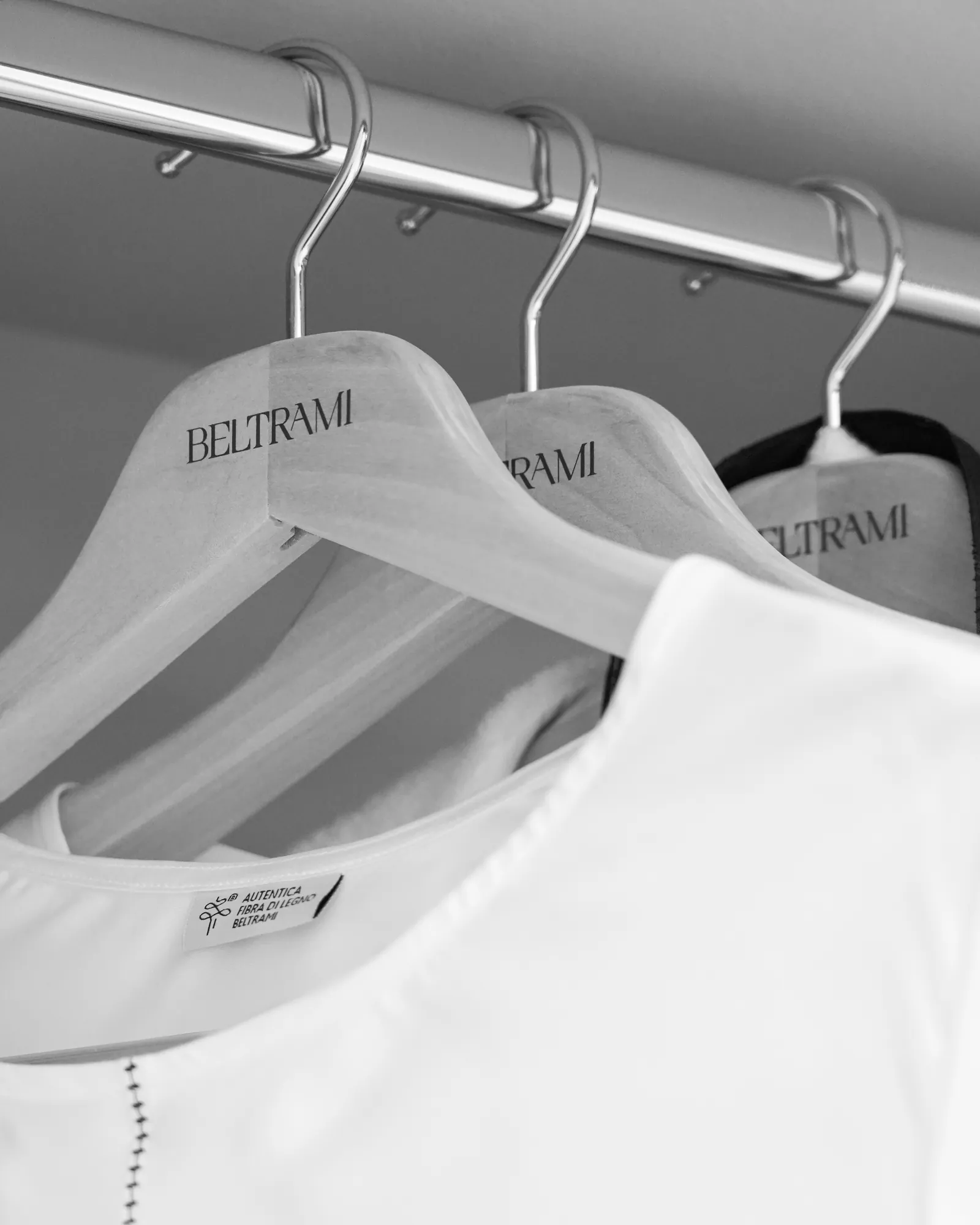 Hangers with the Beltrami logo in the wardrobe