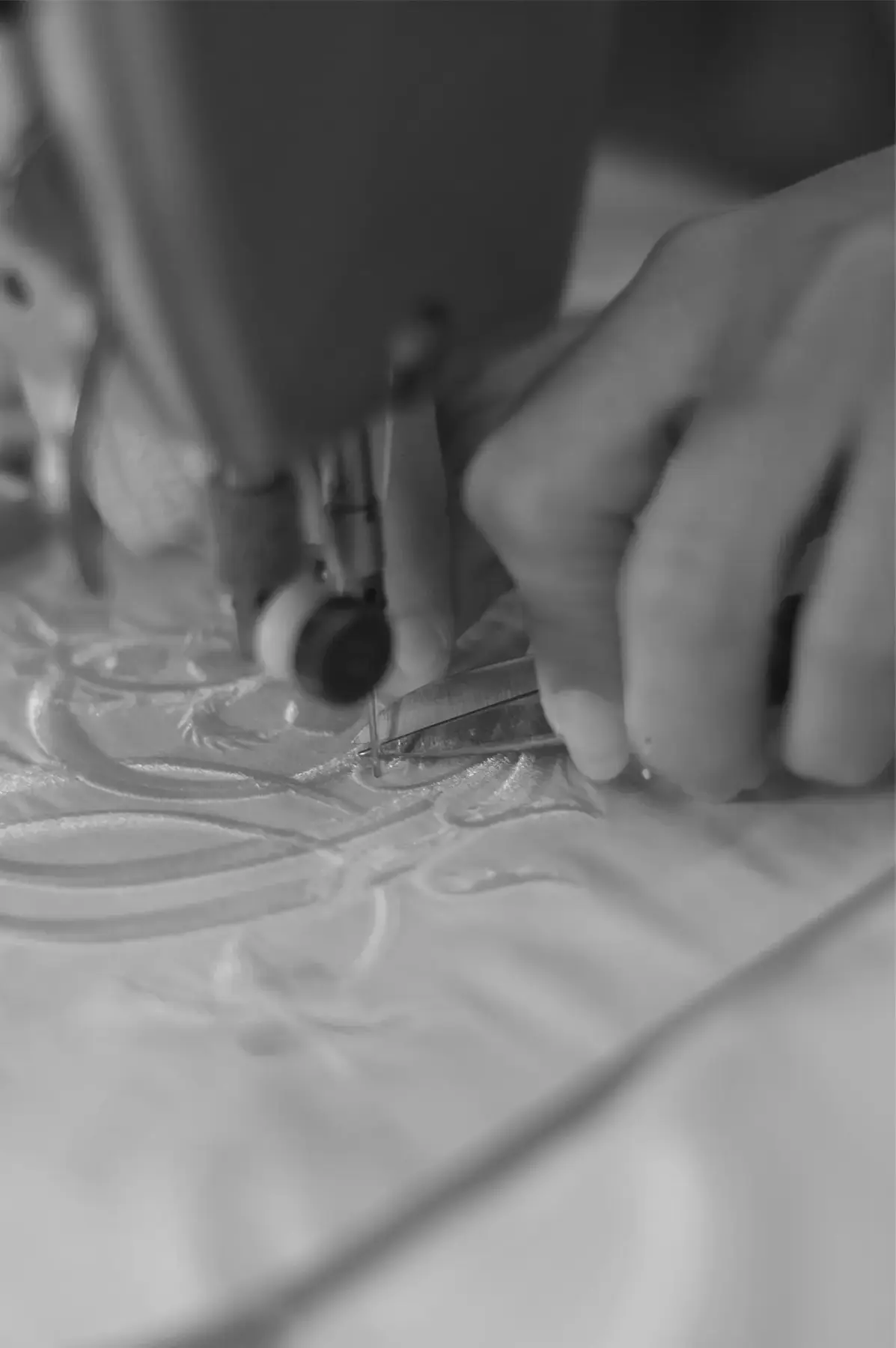 Hands finishing a Beltrami textile