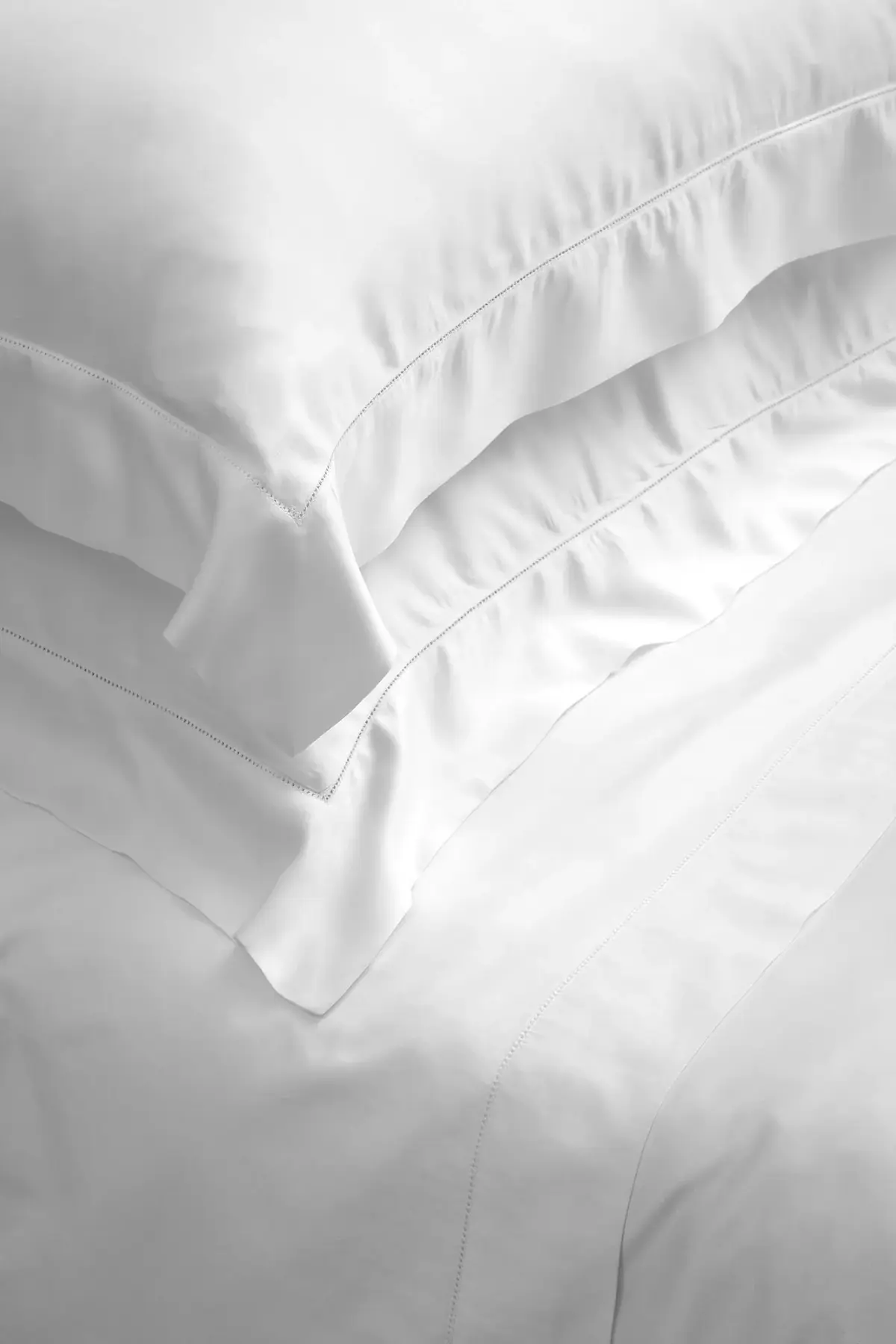 Beltrami pillows resting on a made bed