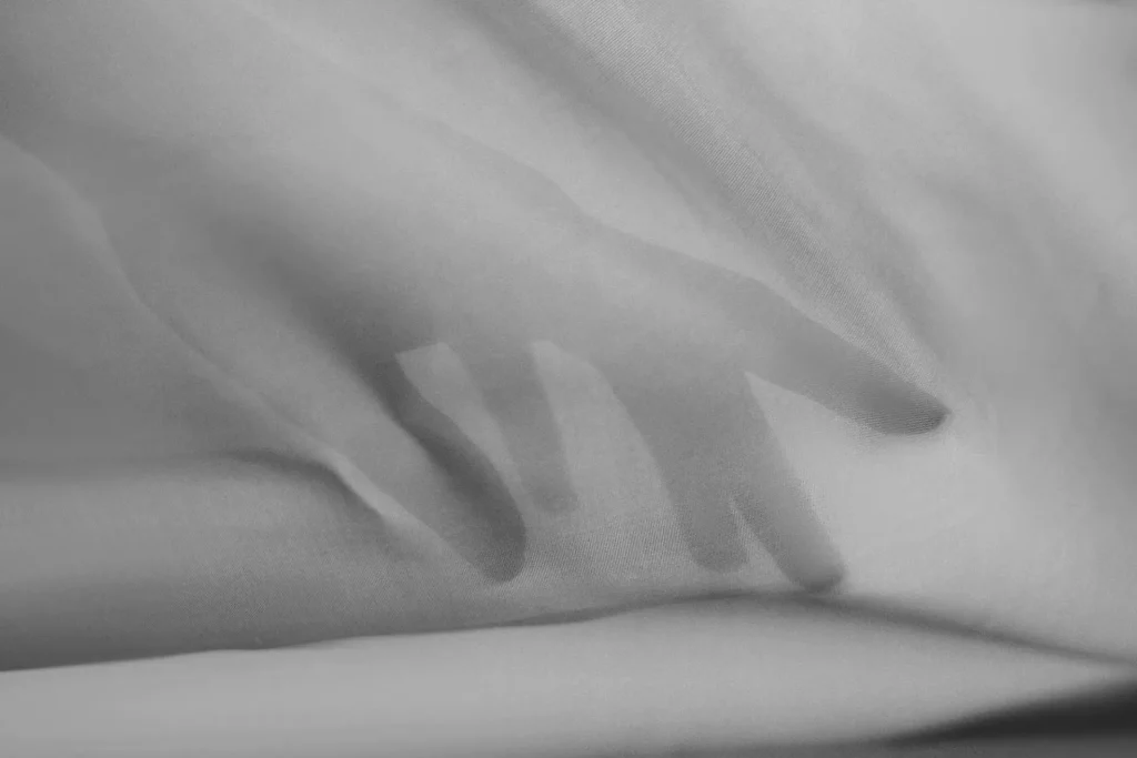 A hand reading the surface of a Beltrami cloth