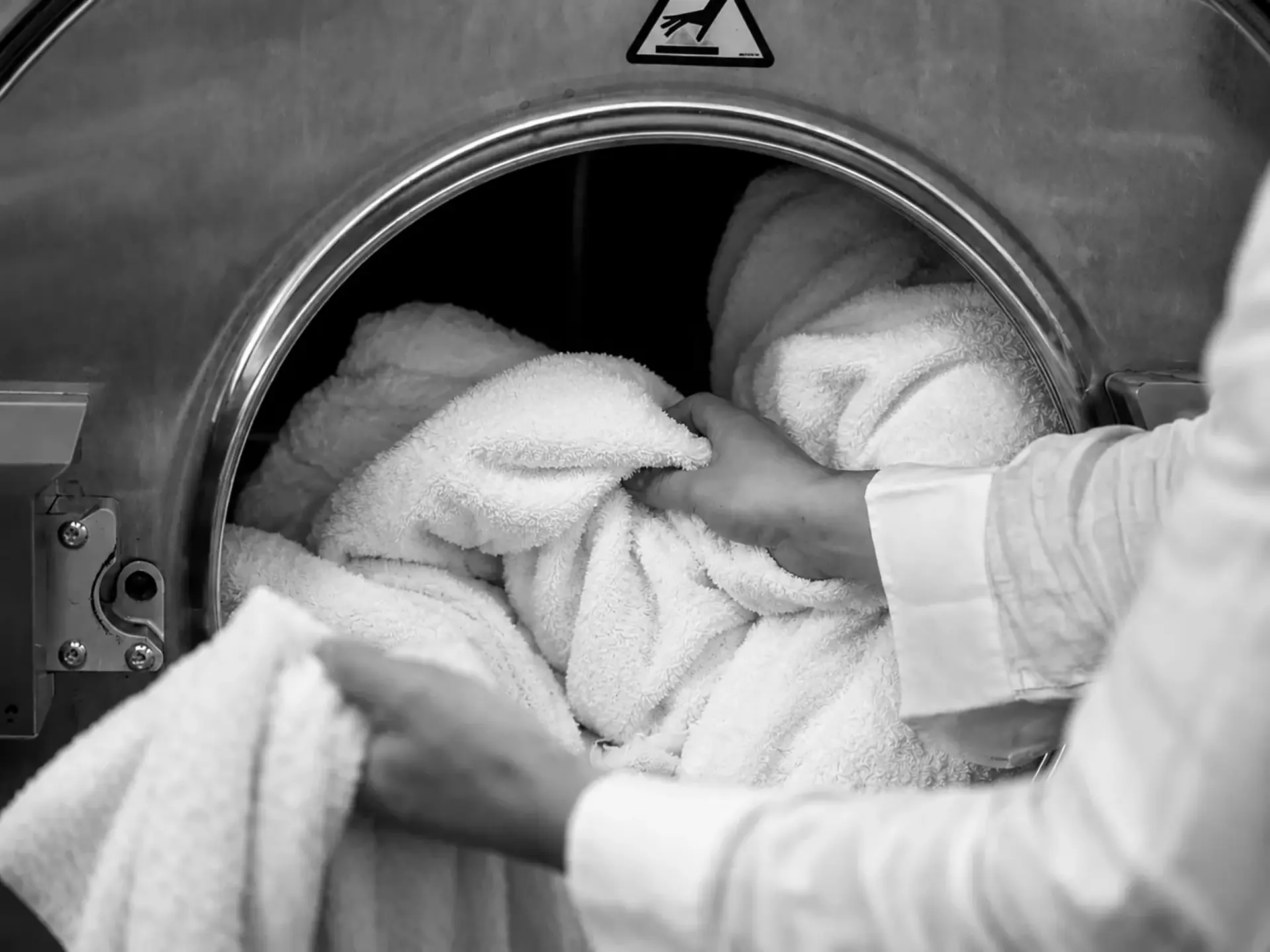 Hands clutching Beltrami bath linens